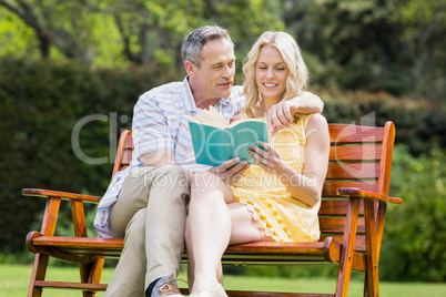 Happy couple reading a book