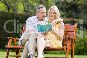 Happy couple reading a book