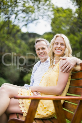 Happy couple sitting on a bench