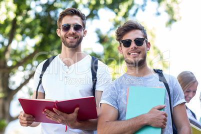 Hip friends holding notebooks
