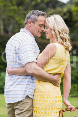 Happy couple holding picnic basket