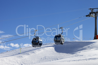 Gondola lift on ski resort at windy sun day