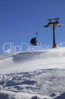 Gondola lift on ski resort at windy sun day