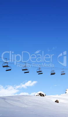 Chair-lift and blue sky at evening