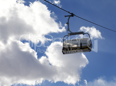 Chair-lift and sunlight sky
