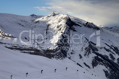 Ski slope with snow cannon at evening