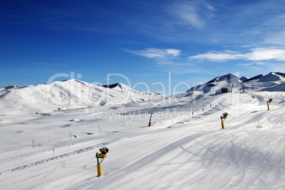 Ski slope with snowmaking at sun day