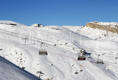 Ski slope and chair-lift at sun day