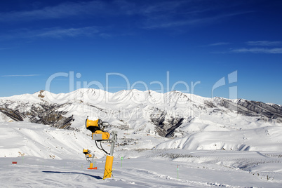 Snowmaking in ski slope at sun day