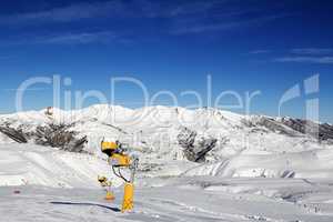 Snowmaking in ski slope at sun day