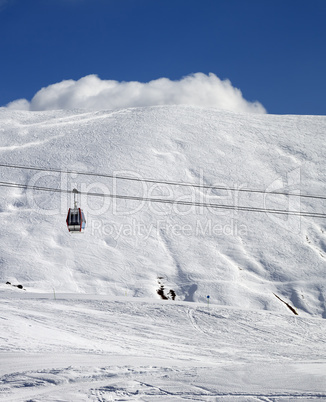 Gondola lift and ski slope at sun day