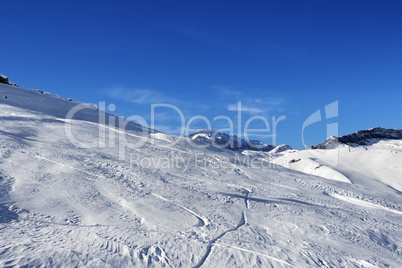 Off-piste slope at sun day