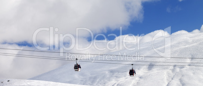 Panoramic view on gondola lifts and off-piste slope at sun day