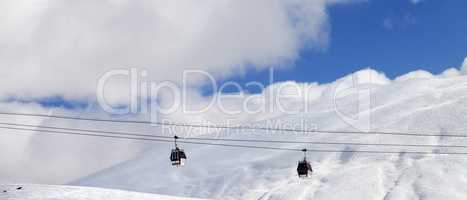 Panoramic view on gondola lifts and off-piste slope at sun day