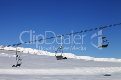 Chair-lift and blue sky at sun day