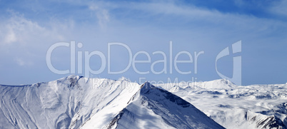 Panoramic view on snowy mountains at sunny day