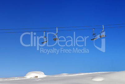 Chair-lift and blue clear sky at sunny day