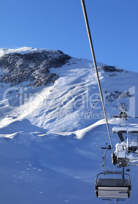 Off-piste slope and chair-lift after snowfall