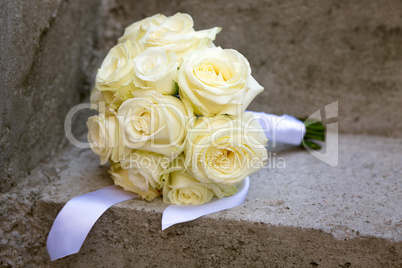 Wedding bouquet laid on a concrete stairs