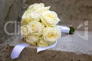Wedding bouquet laid on a concrete stairs