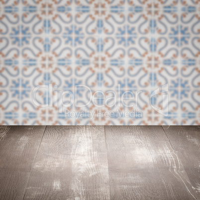 Wood table top and blur vintage ceramic tile pattern wall