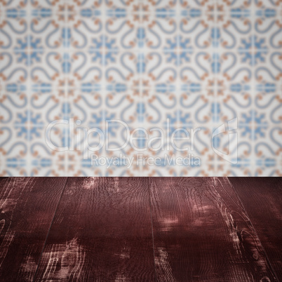 Wood table top and blur vintage ceramic tile pattern wall