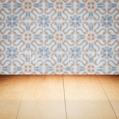 Wood table top and blur vintage ceramic tile pattern wall Wood table top and blur vintage ceramic tile pattern wall