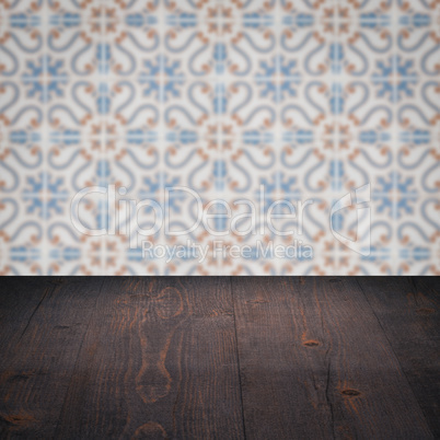 Wood table top and blur vintage ceramic tile pattern wall