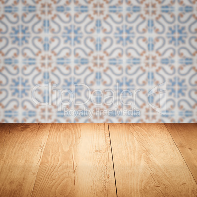 Wood table top and blur vintage ceramic tile pattern wall