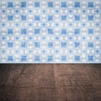 Wood table top and blur vintage ceramic tile pattern wall