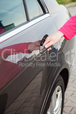 Woman opens car door