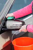 Woman cleans the car