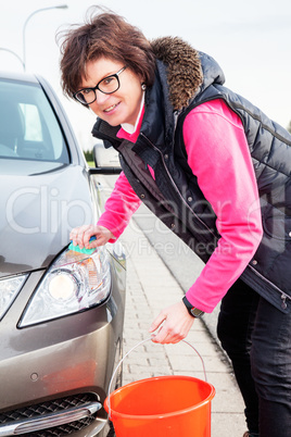 Woman cleans the car