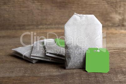 Teabags on wooden background