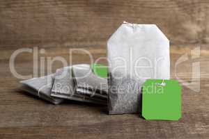 Teabags on wooden background