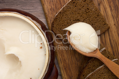 Melted fat and brown bread on chopping board