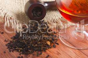 Glass of cognac and pipe with tobacco