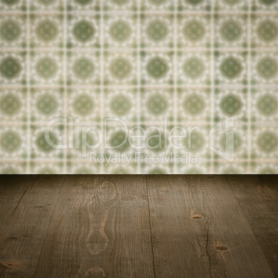 Wood table top and blur vintage ceramic tile pattern wall