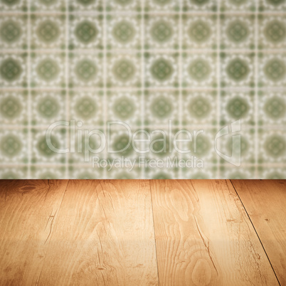 Wood table top and blur vintage ceramic tile pattern wall