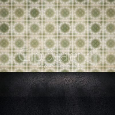 Wood table top and blur vintage ceramic tile pattern wall