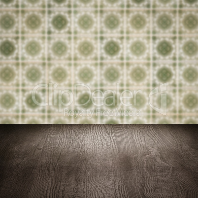 Wood table top and blur vintage ceramic tile pattern wall Wood table top and blur vintage ceramic tile pattern wall