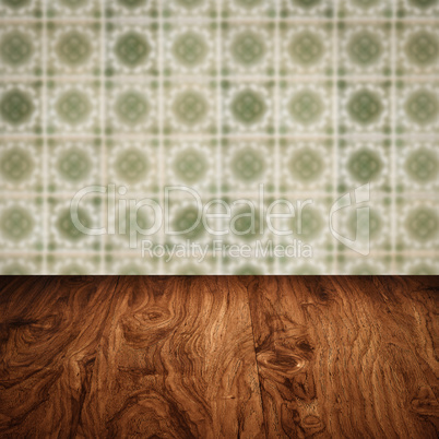 Wood table top and blur vintage ceramic tile pattern wall