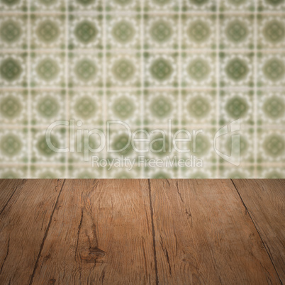 Wood table top and blur vintage ceramic tile pattern wall