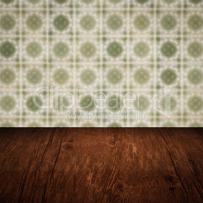 Wood table top and blur vintage ceramic tile pattern wall