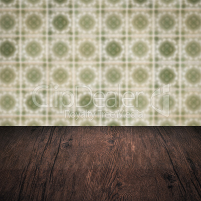 Wood table top and blur vintage ceramic tile pattern wall