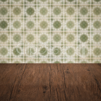 Wood table top and blur vintage ceramic tile pattern wall