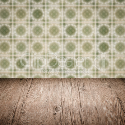 Wood table top and blur vintage ceramic tile pattern wall