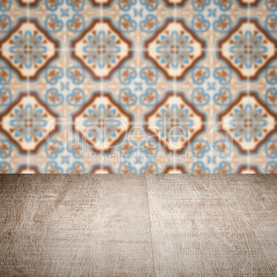 Wood table top and blur vintage ceramic tile pattern wall