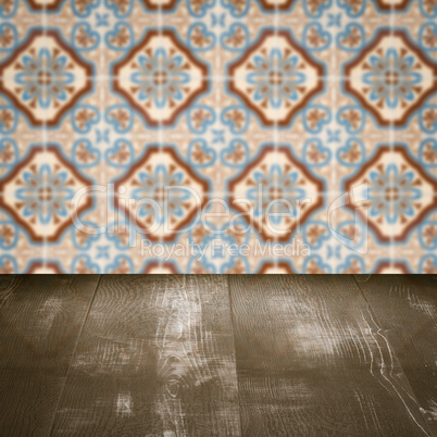 Wood table top and blur vintage ceramic tile pattern wall