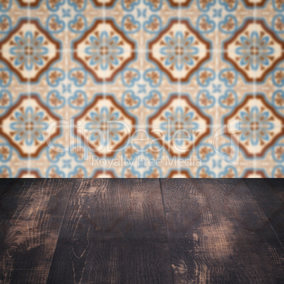 Wood table top and blur vintage ceramic tile pattern wall